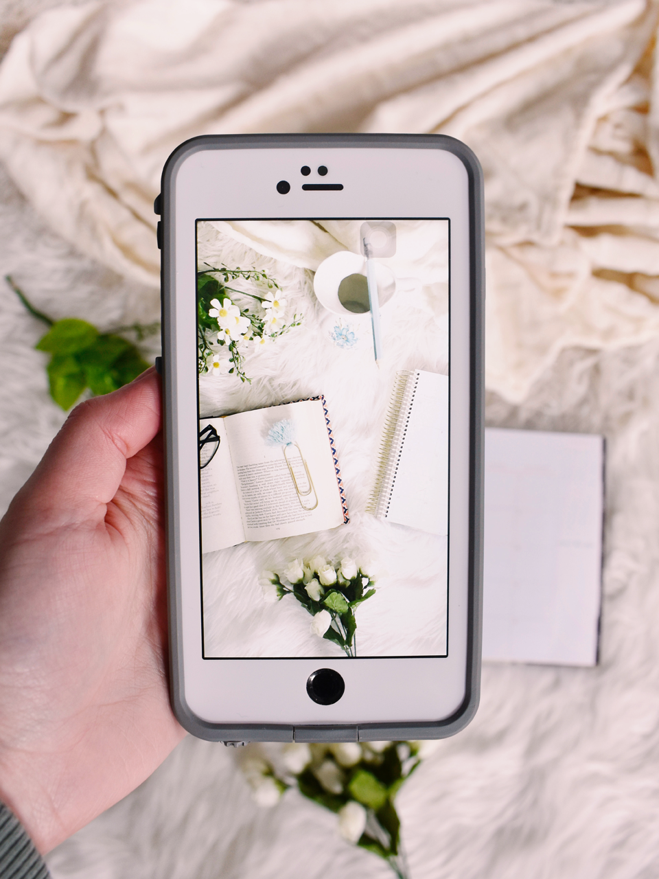 professional influencer creates a flatlay image with phone
