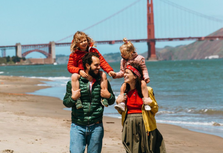 Influencer family enjoys the beach in front of California's Golden Gate Bridge